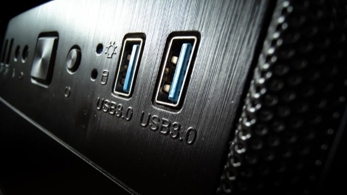 Front panel of a computer case with blue USB 3.0 ports