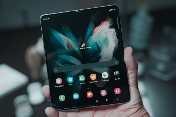 Fully unfolded foldable phone showing home screen interface