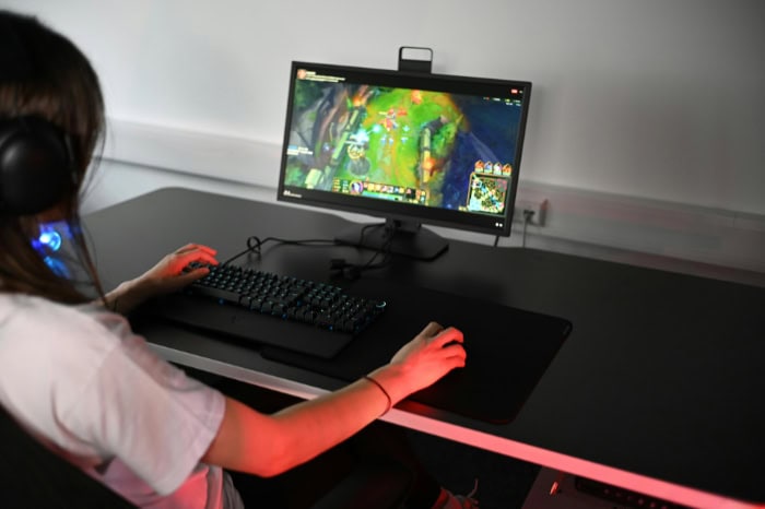 Gamer playing League of Legends on gaming monitor setup