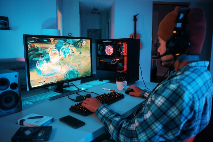 Gamer playing MOBA game on high end PC setup