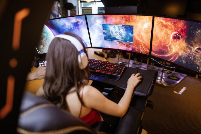 Gamer using curved monitors with space themed wallpapers