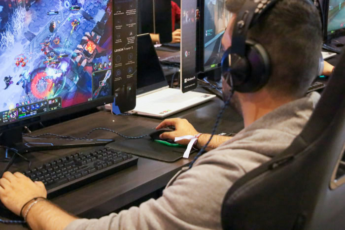 Gamer with headphones playing a PvE computer game