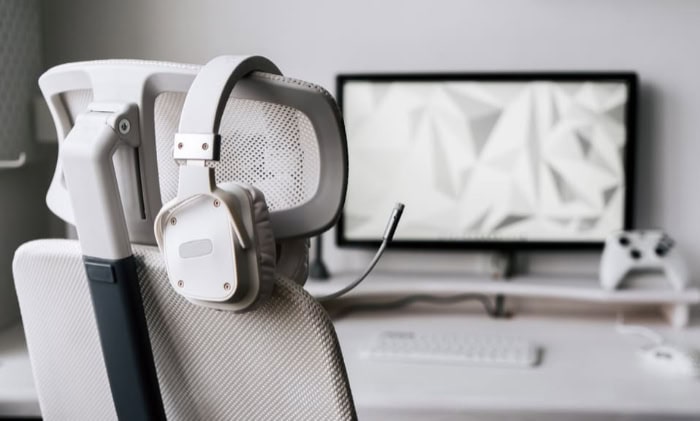 Gaming headset on desk near computer monitor