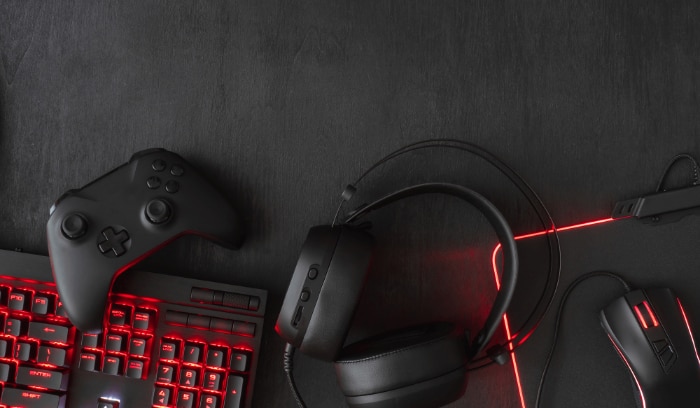 Gaming peripherals on a dark background with LED backlighting