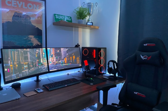 Gaming setup with dual monitors and a black gaming chair