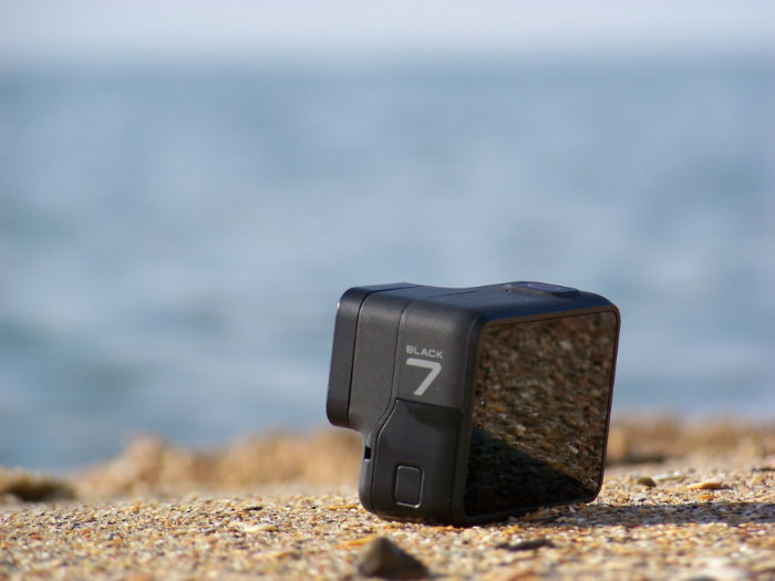 GoPro Hero 7 Black camera on sandy beach
