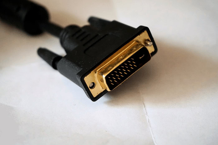 Gold plated DVI cable connector on white surface