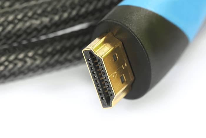 Gold tipped HDMI cable connector on braided blue cable