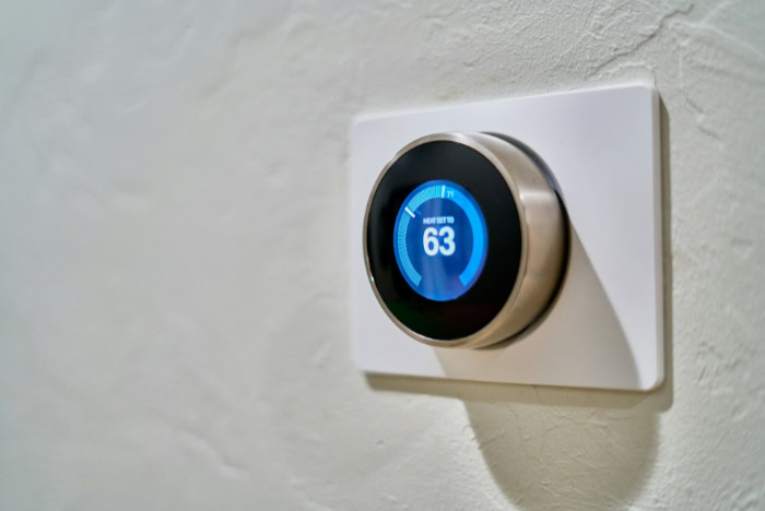 Google Nest Learning Thermostat mounted on white wall