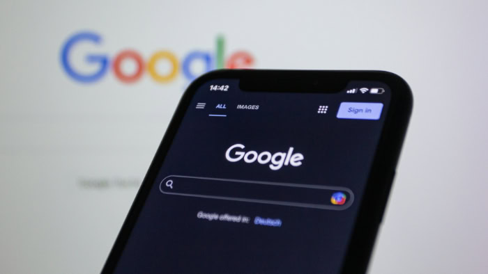 Google search homepage on dark mode smartphone screen