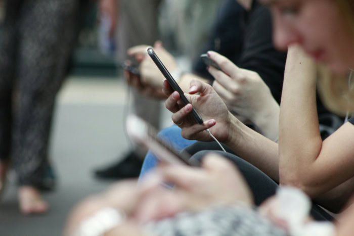 Group of people using mobile phones