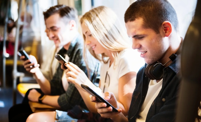 Group of people using smartphones in the subway