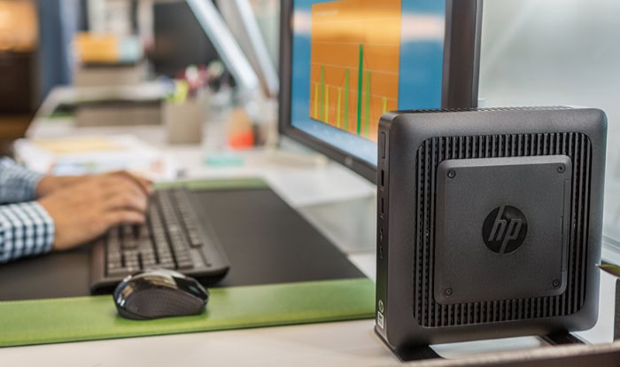 HP thin client beside monitor on workstation