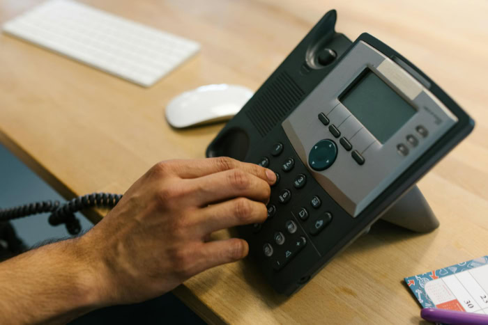 Hand dialing a VoIP office phone device