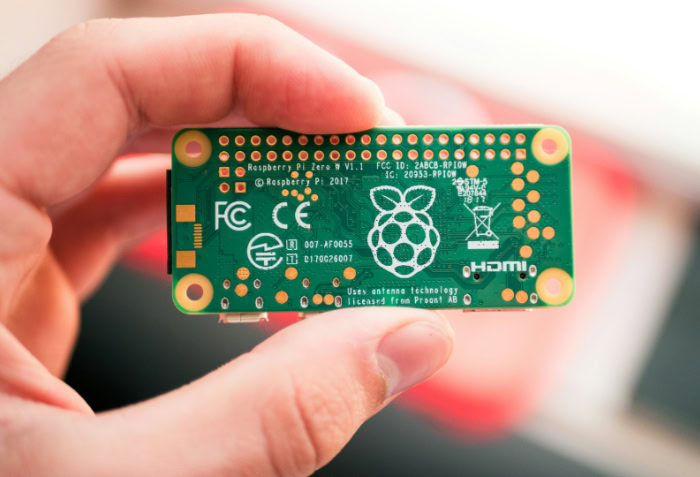 Hand holding Raspberry Pi Zero W board back
