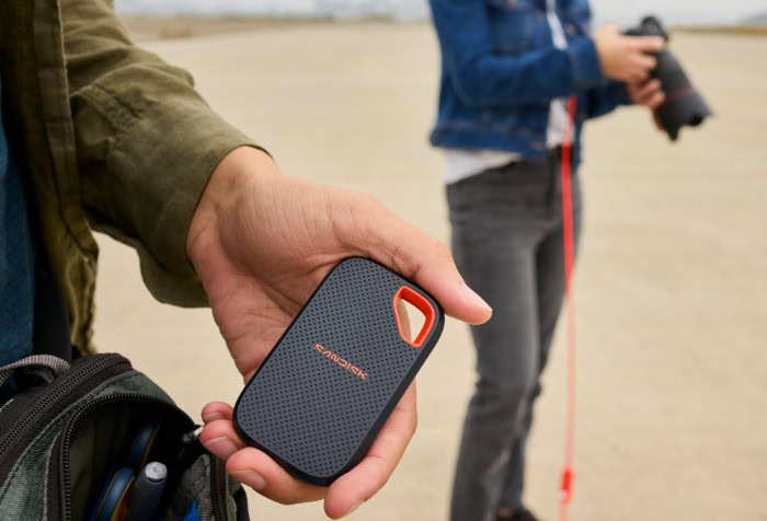 Hand holding SanDisk Extreme portable SSD outdoors
