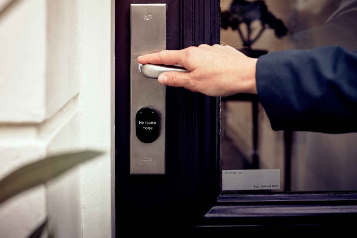 Hand touching smart lock with welcome home display
