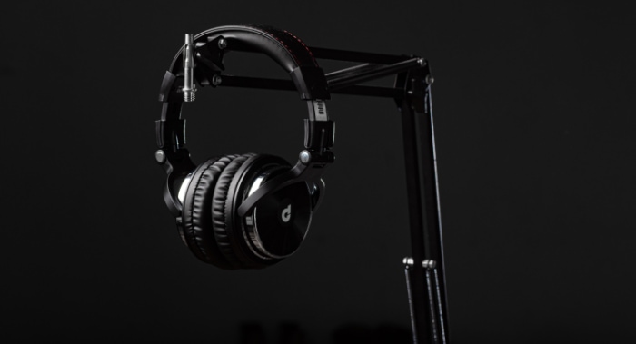 black headphone on black headphone stand