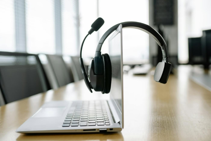 Headset resting on an open laptop displaying setup