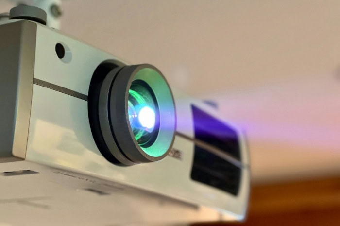 Home projector with a glowing lens during operation