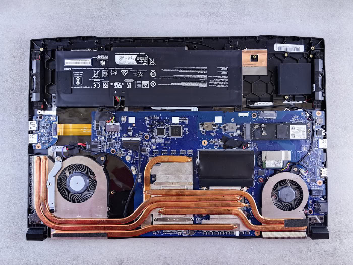 Internal laptop hardware showing motherboard and dual fans