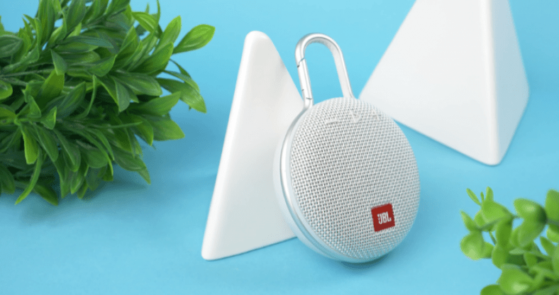 White JBL CLIP 3 on blue surface
