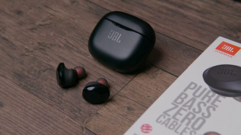 Black JBL Tune 120TWS on wooden surface