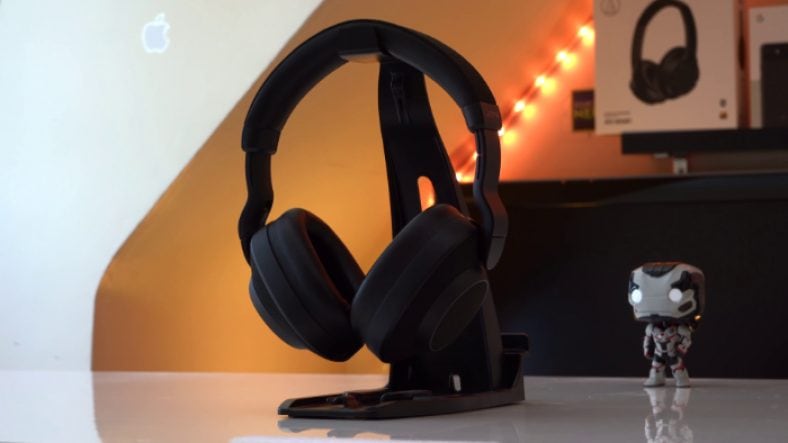 Black Jabra Elite 85h near iron man action figure on white table