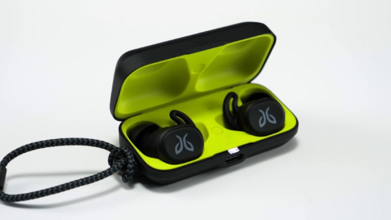Black Jaybird Vista earbuds inside open case on white surface