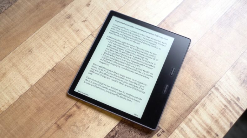 Black Kindle Oasis on wooden surface