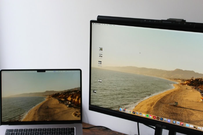 Laptop connected to an external monitor displaying beach