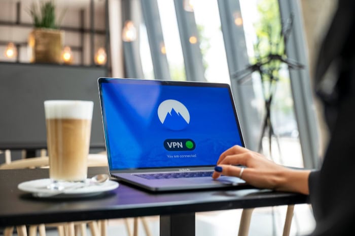 Laptop displaying VPN connection screen in cafe setting