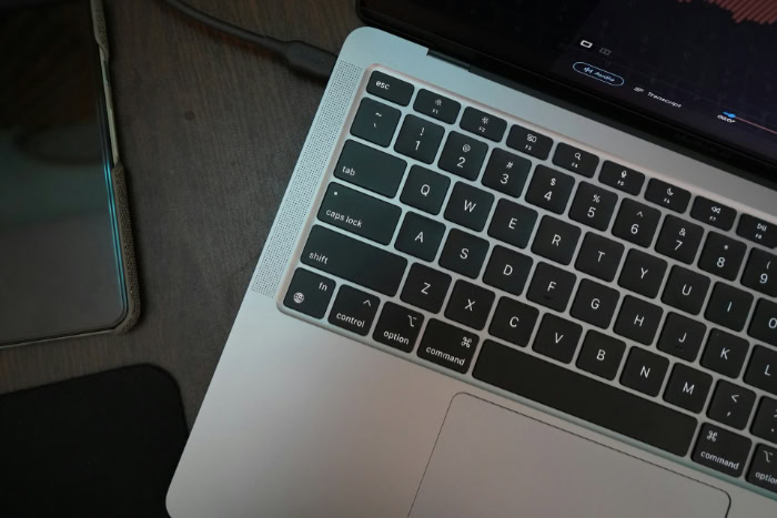 Laptop keyboard with video editing software on screen