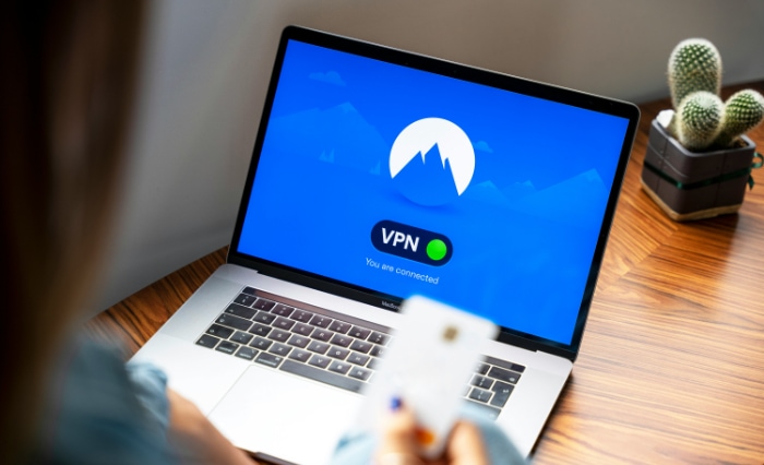 Laptop on a desk showing a connected VPN status