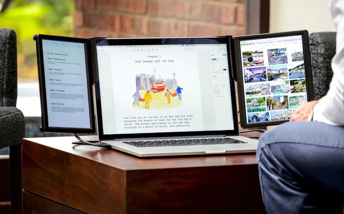 Laptop on a desk with two external monitors