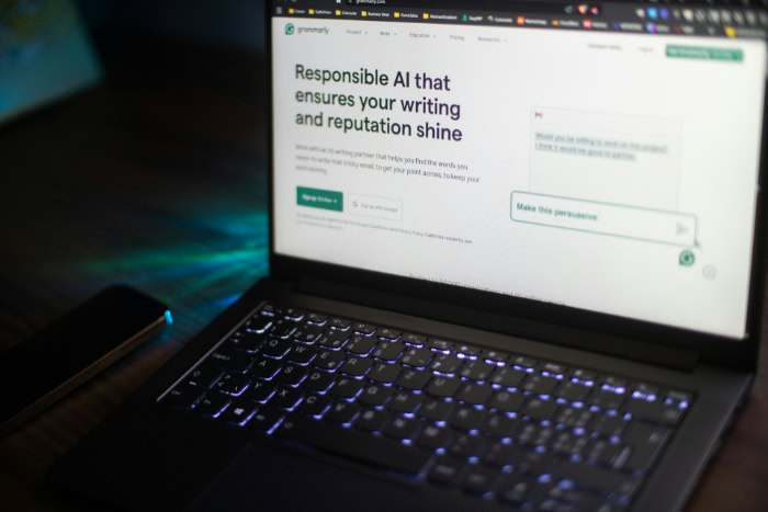 Laptop screen showing Grammarly AI writing assistant website