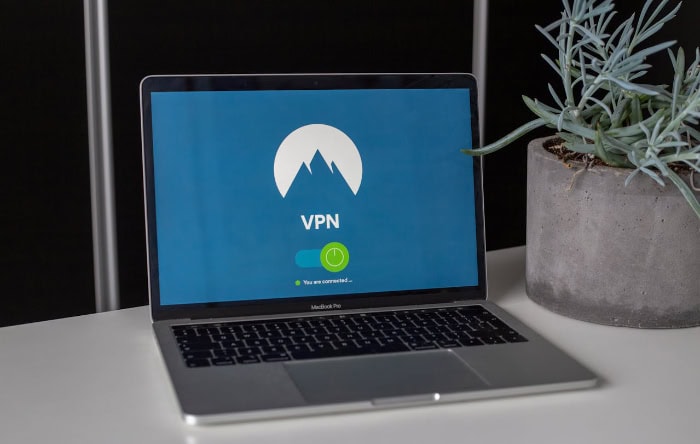 Laptop screen showing VPN connection interface with mountain logo