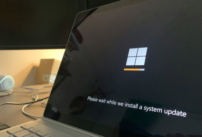 Laptop screen showing Windows system update progress