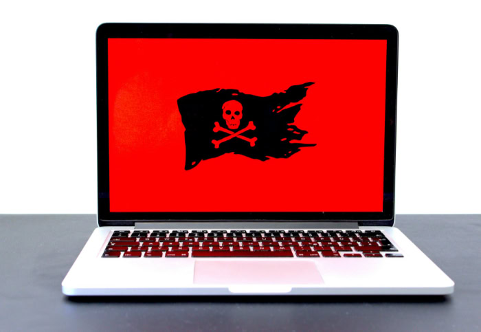 Laptop screen with skull and crossbones