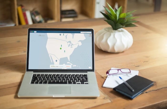 Laptop with VPN application on wooden desk