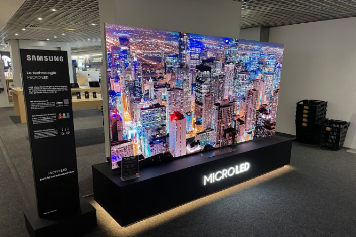 Large Samsung MicroLED TV displaying a city skyline