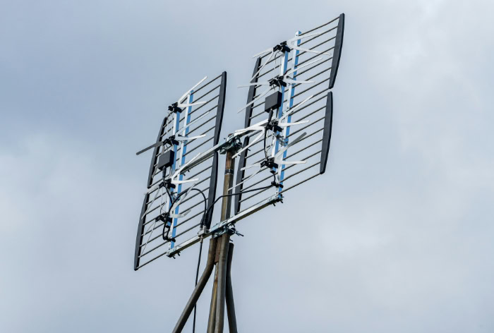 Large directional television antenna against an overcast sky