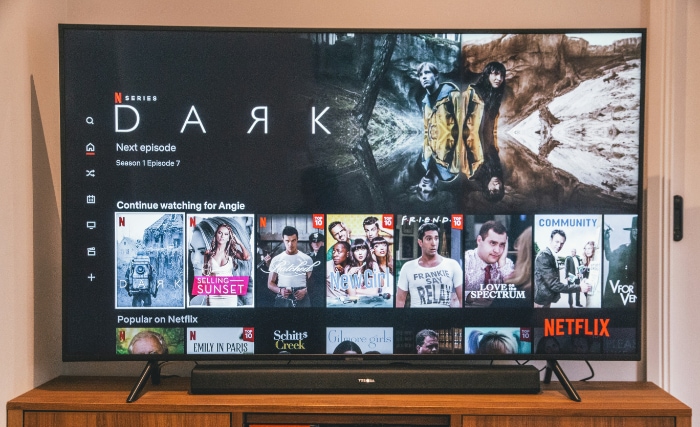 Living room setting with a Netflix homepage displayed on a flat screen TV