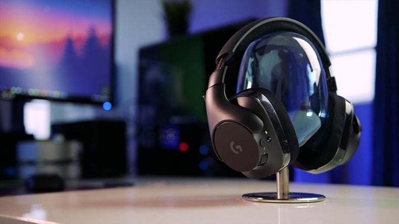 Black Logitech G533 on clear glass