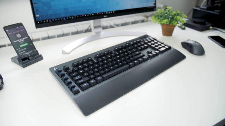 Black Logitech G613 on white table near mouse