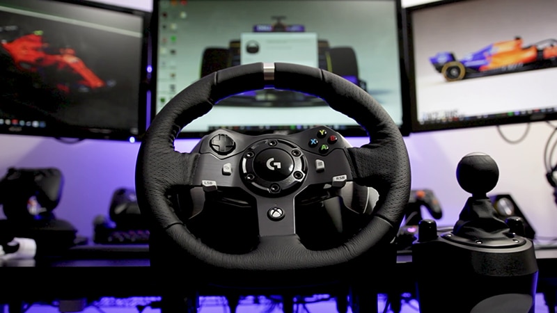Black Logitech G920 wheel with shifter on black table