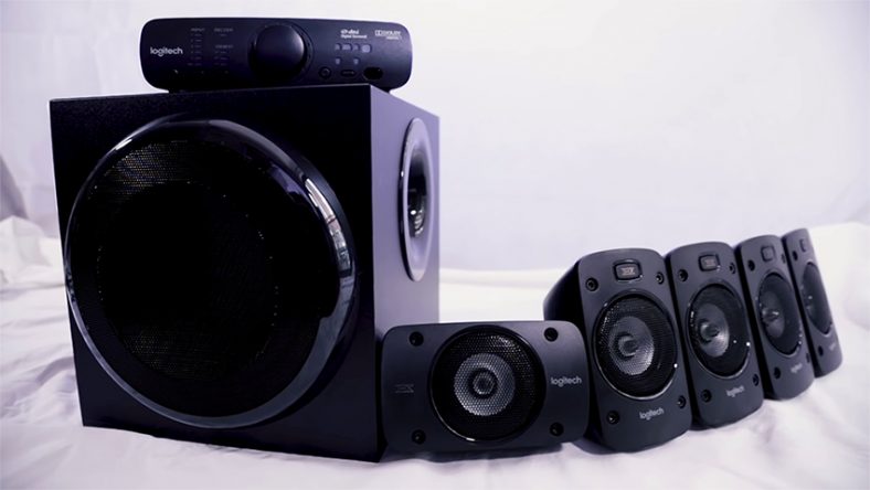 Black Logitech Z906 on white cloth