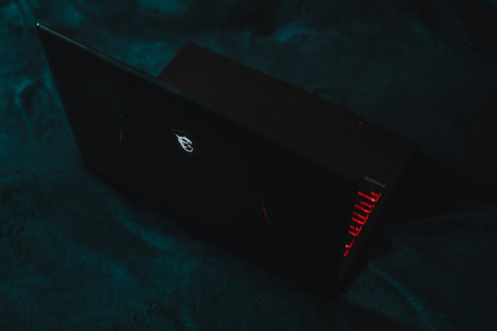 MSI gaming laptop with illuminated logo in dark setting