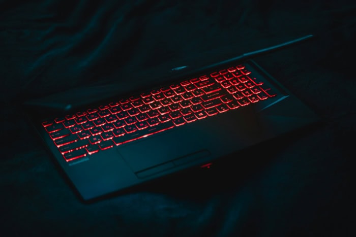 MSI laptop keyboard with red backlit keys in dark