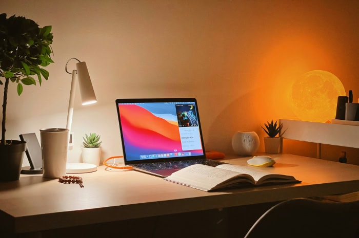 MacBook Air on a cozy well lit desk setup at night